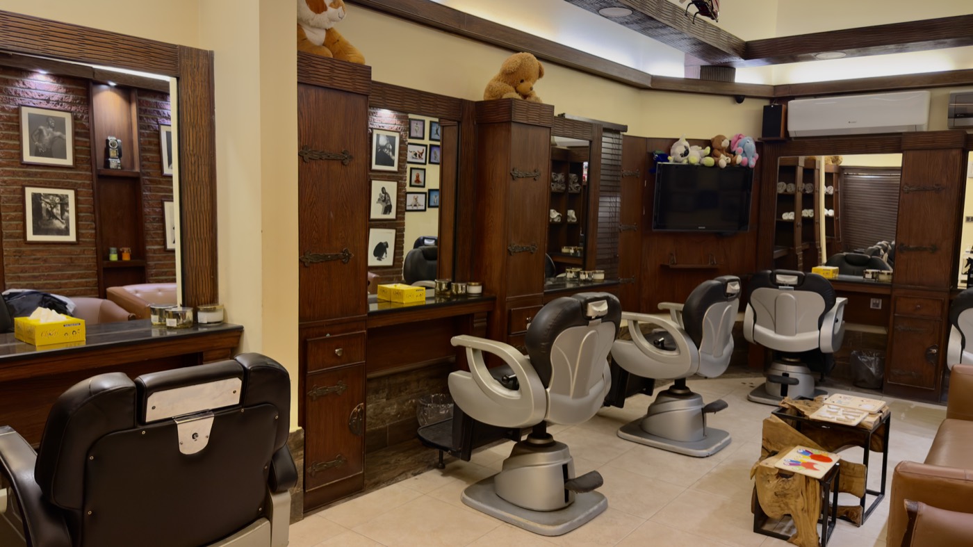 Reclining wash chairs beside the barber stations at the Stadium branch