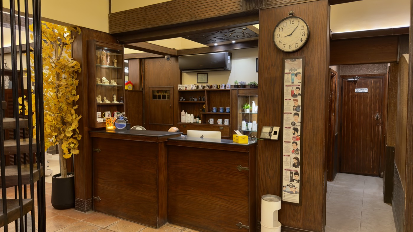 The wooden reception counter and product shelves at the Stadium branch