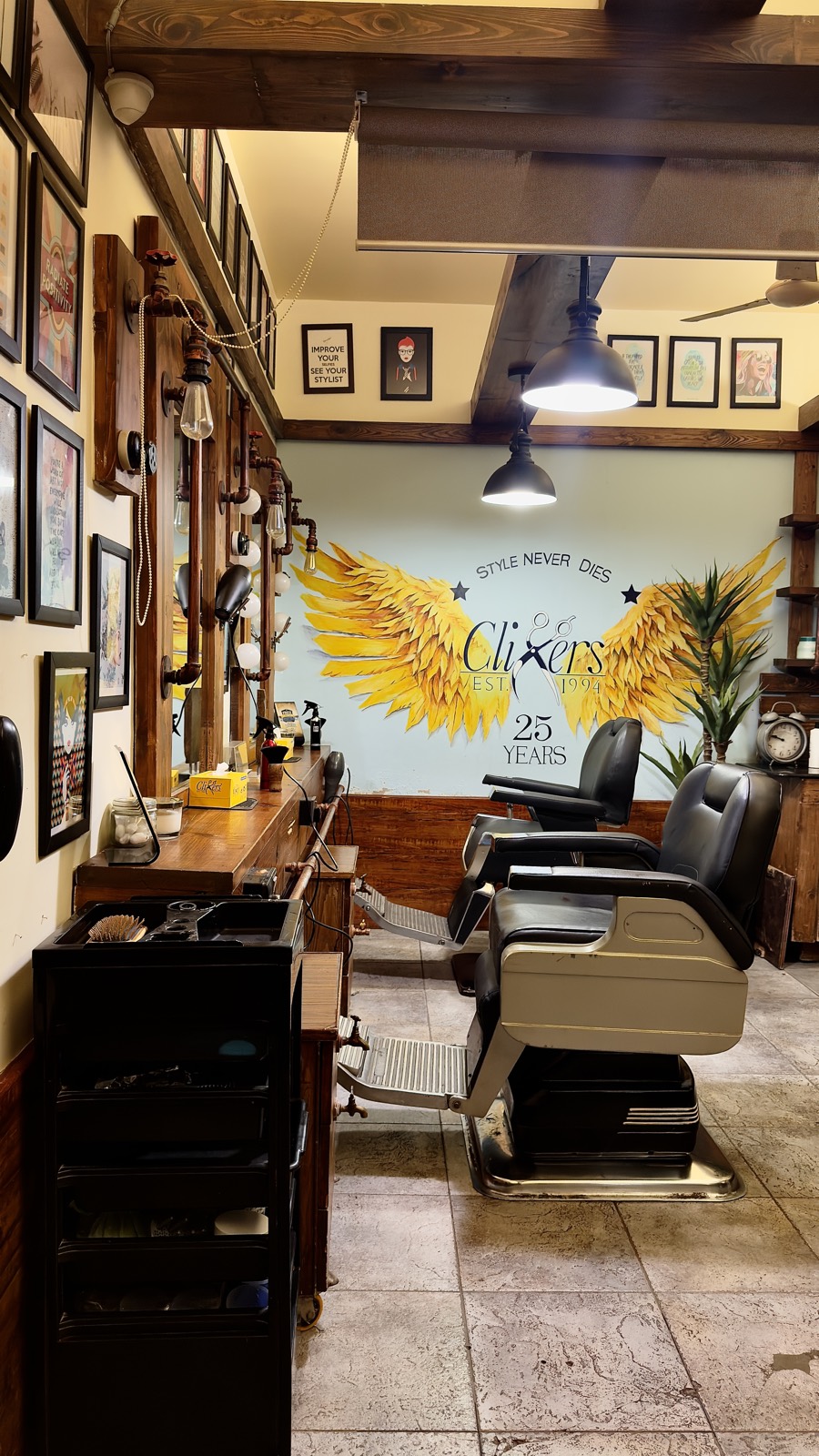 Barber chairs and stations running down to the wings mural at the Zamzama branch