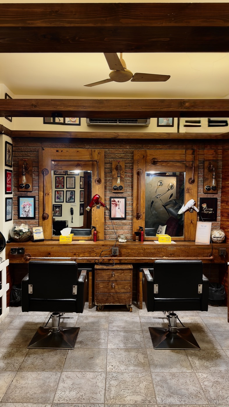 Two styling chairs facing wood-framed mirrors at the Zamzama branch